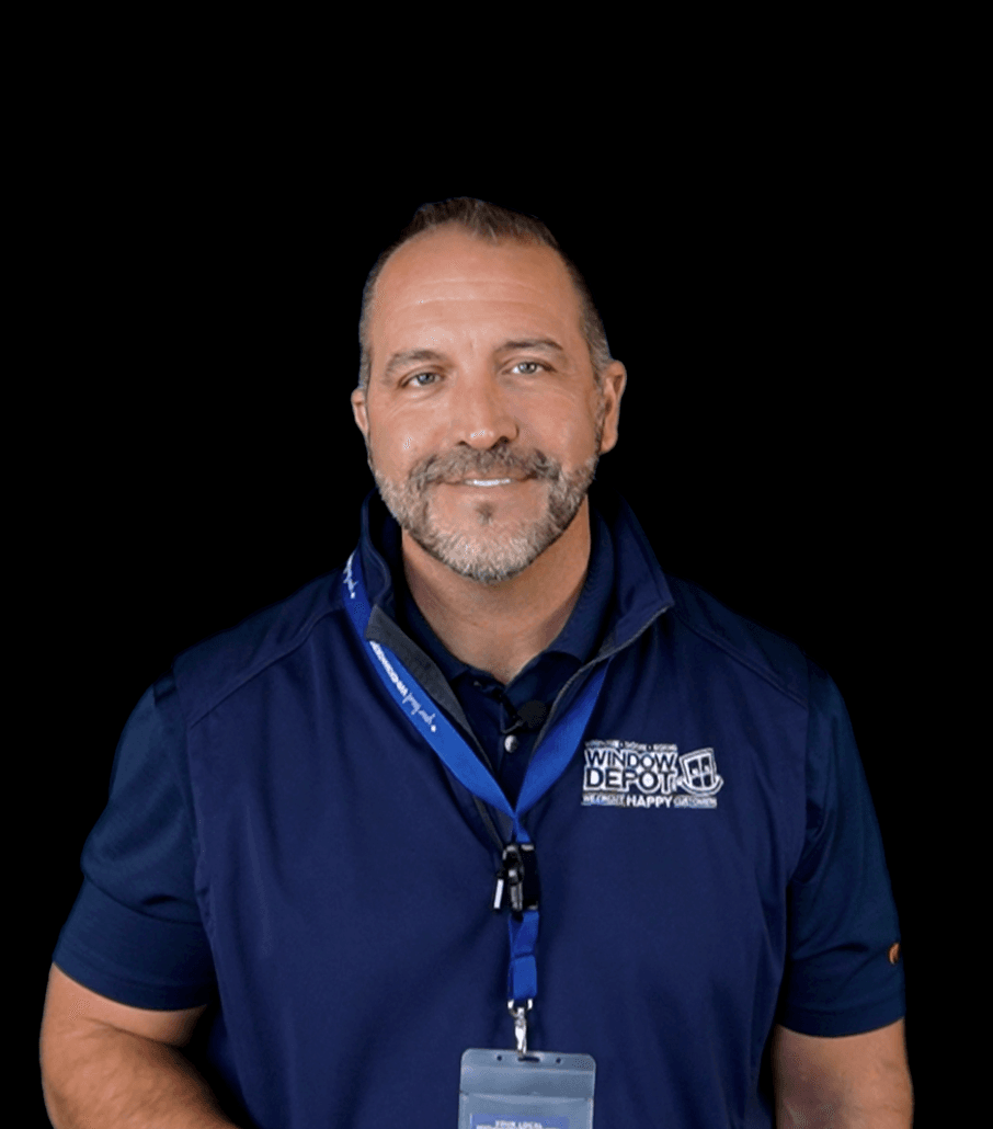 Man wearing navy Window Depot polo shirt with employee badge on blue lanyard, smiling at camera against black background